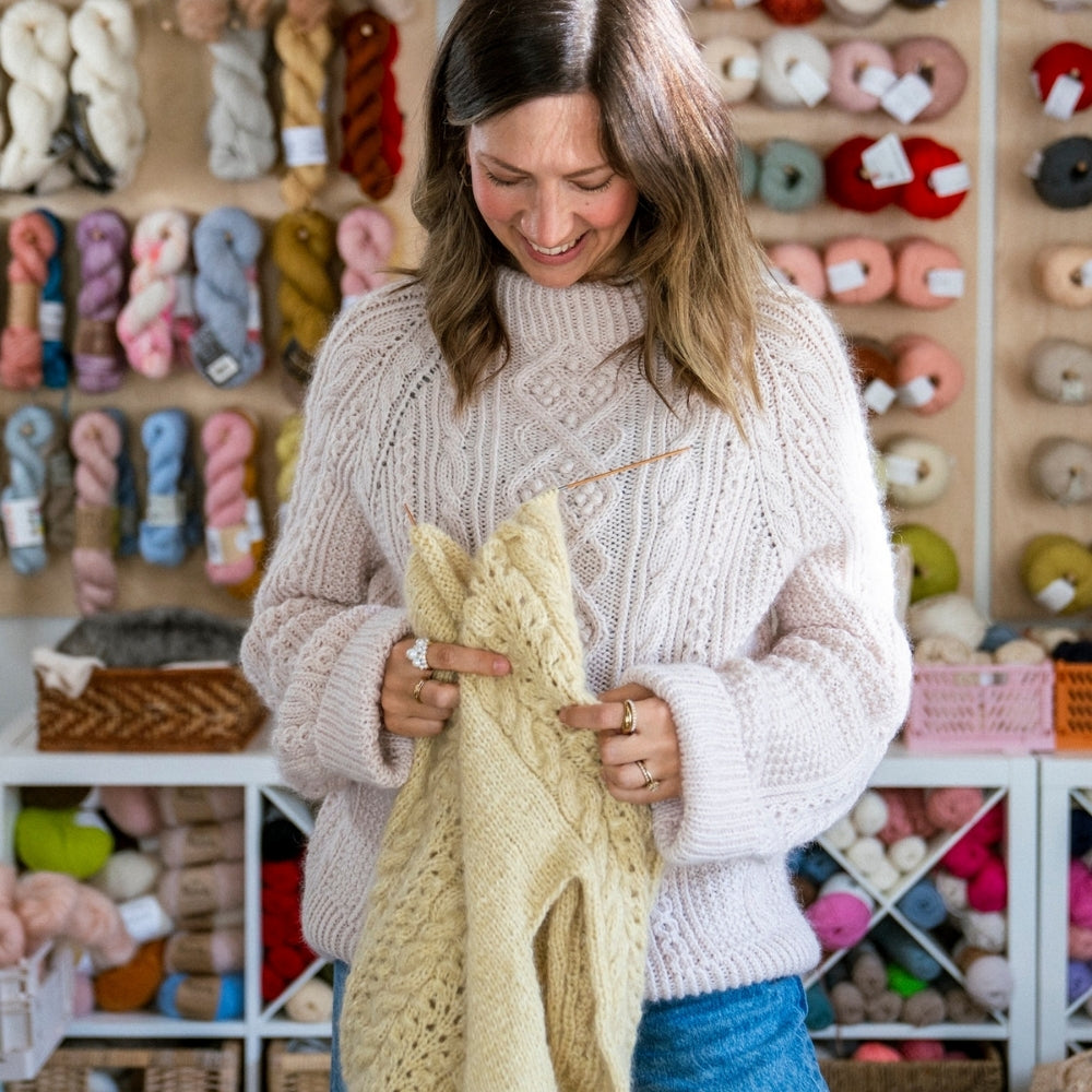 veronika the designer holding a yellow sweater