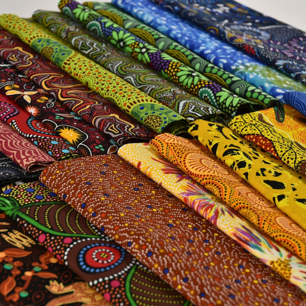 Collection of colorful fabric rolls with various patterns