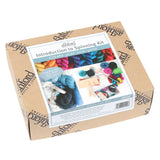 Booklet for a yarn art kit, providing step-by-step instructions for beginners on spinning yarn with hand carders and drop spindle.