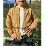 A young girl wearing a yellow cardigan, featuring a feminine lace design and button bands along the front.