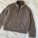 The Dagmar Zipper Sweater showcases a beautiful cable pattern, crafted with a ribbed neck and double knitted fronts for a zipper.