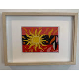 Beautiful sun stitch kit frame it in a white wall.
