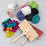 A collection of vibrant yarns and brushes, included in a beginner's spinning kit with essential tools and step-by-step guidance.