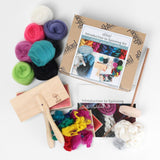  Complete spinning kit for beginners, including a wooden paddle, brush, and yarn, with detailed instructions for fiber preparation.