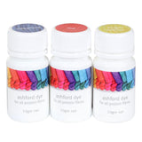  Three dye bottles in primary colors: red, sapphire, and bright yellow, for crafting a rainbow of colors with vinegar.