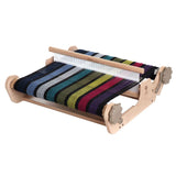 A vibrant, multi-colored loom on a wooden table, perfect for sampling yarns and suitable for weavers of all skill levels.