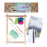 The wheel knitting kit includes yarn, needles, and a wooden frame for creating trendy hand-woven wall hangings.